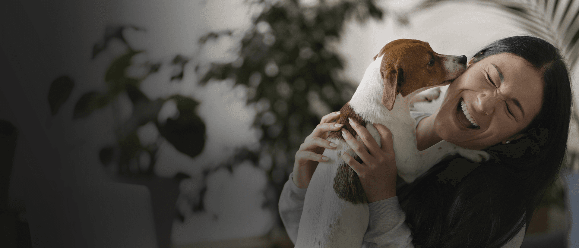 Woman happily holding a small dog