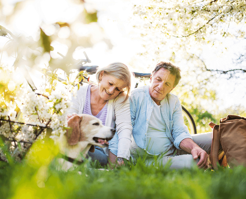 A couple with their dog outdoors